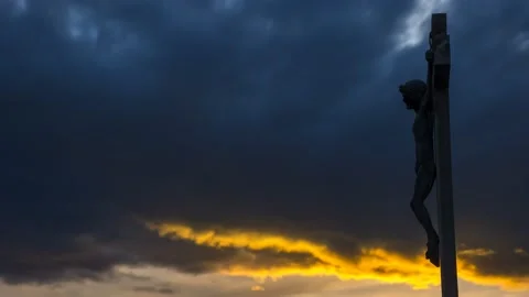 Jesus Christ on the cross against dramatic cloudy sky. Crucifixion, religion  Stock Footage