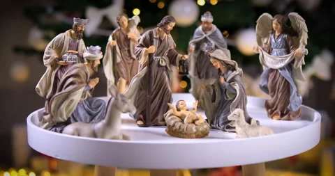 Jesus Christ Nativity scene in front of Christmas tree lights Stock Footage 137915601
