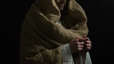 Jesus Christ in robe holding string of b... | Stock Video | Pond5
