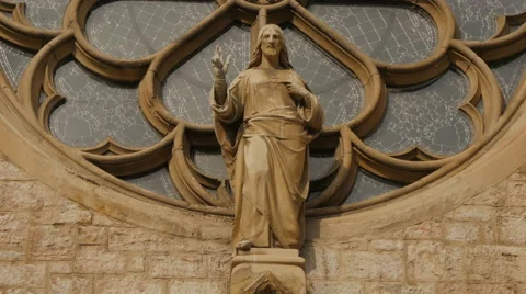 Jesus Christ statue in front the rose window of Sacred Heart Cathedral, Sarajevo Stock Footage 59840873