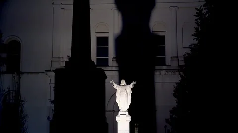 Jesus Christ statue with the huge shadow on the back side of St. Louis Cathedral Stock Footage 124657466