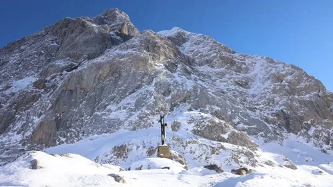 Jesus Christ in the summit of icing monutain, snow and sun Stock Footage 239339772