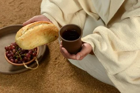 Jesus hands holding bread and wine Stock Photos