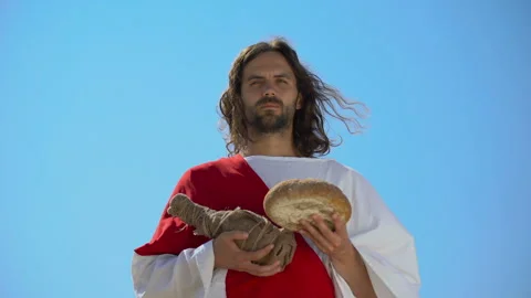 Jesus holding bread and bottle of wine, sharing sacramental meal, Holy Eucharist Stock Footage 112649502