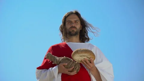 Jesus holding bread and bottle of wine, sharing sacramental meal, Holy Eucharist Stock Footage 112655061