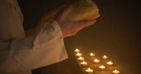 Jesus Holding Bread in Candlelight for Passover Stock Footage 318436596