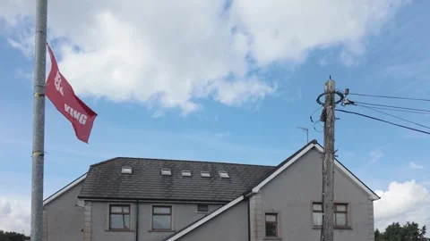 Jesus is King Flag in Red with White Lettering Against Blue Sky Stock-Footage 317701308