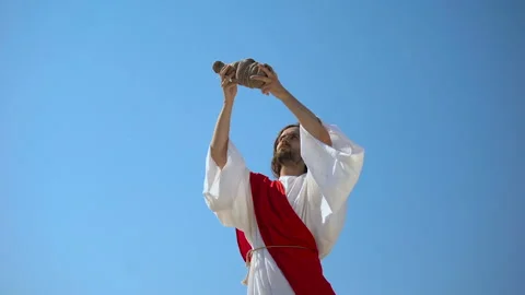 Jesus raising wine in hands to sky, blessing sacramental Eucharist beverage Stock Footage 112654752