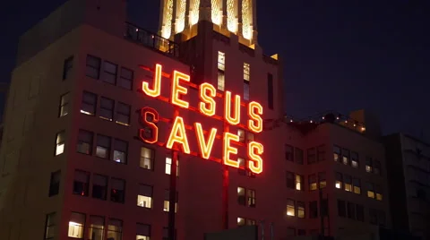 JESUS SAVES neon sign on building and Light Effects Stock Footage