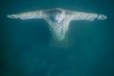 Jesus statue from above while diving in a lake Stock Photos