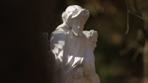 Jesus statue dappled light Stock Footage 83351692