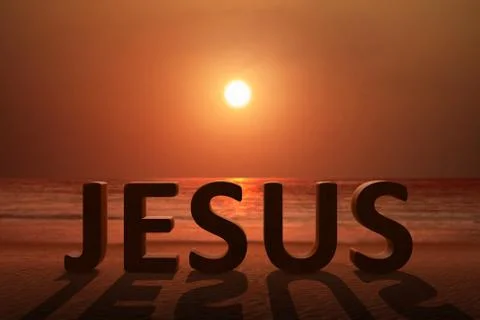 Jesus text on the sandy beach Stock Photos