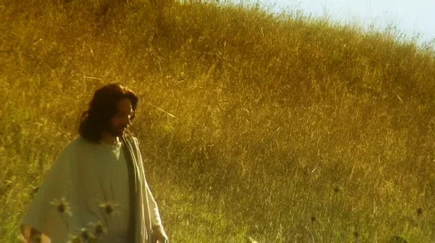 Jesus walks in field Stock Footage