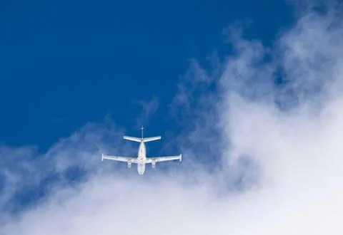 Jet against blue sky and clouds Stock Photos