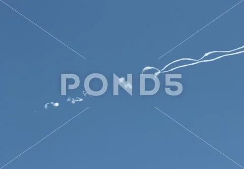 Jet airline traces shape in the blue sky Stock Photos