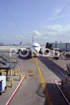 Jet Airliner Parked At An Airport Gate Stock Photos