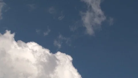 Jet airliner passing through the spring fluffy clouds Stock Footage 91921371