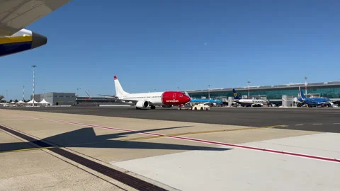 Jet airplane is being pushed back from the gate into flight position Stock Footage 341598434