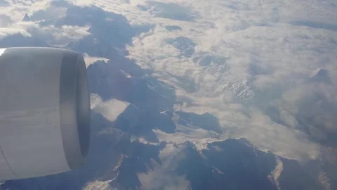 Jet airplane engine flying above clouds and mountains, aerial pov Видео 279835777