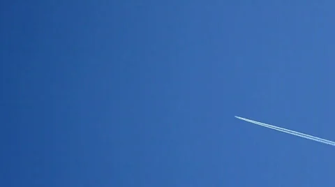 Jet airplane trails in blue sky. Stock Footage