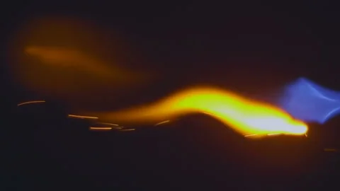 A jet of blue flame with yellow flashes along the flame Stock Footage 130606069