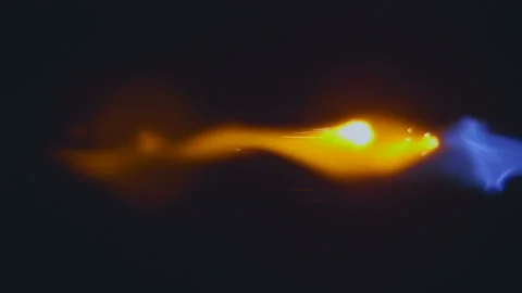 A jet of blue flame with yellow flashes along the flame 動画素材 130606134
