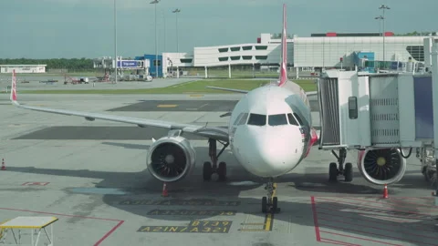 Jet bridge is being moved to an airplane at KLIA Stock Footage 318525447