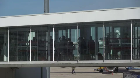 Jet bridge full of queuing travellers slowly boarding plane Stock Footage 119822356
