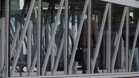 Jet bridge full of travellers boarding plane Stock Footage 158672987
