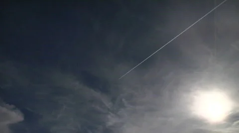 Jet con Trails in Time Lapse with Clouds and Sun Stock Footage 595607