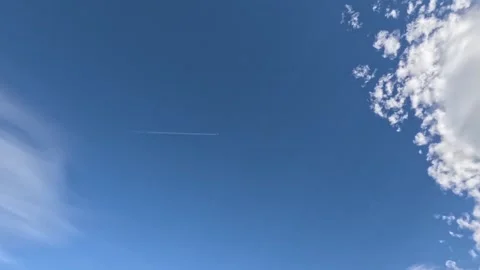 Jet Contrail Through Clouds Stock Footage 261340484