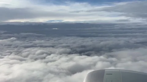 Jet Engine and Cloud Layers Seen from a High-Altitude Flight Stock Footage 339378635