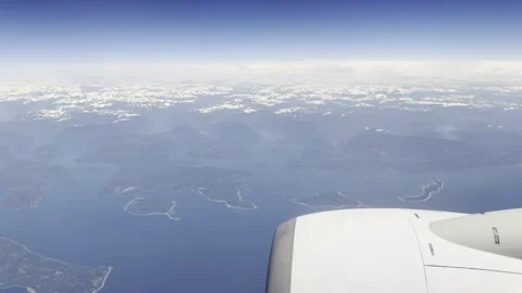 Jet engine cowling over the British Columbia coast and distant peaks Stock Footage 336219616