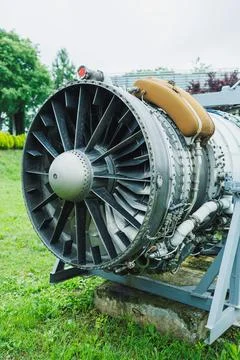 Jet engine displayed outside a museum with green grass and trees in the bac.. Stock Photos