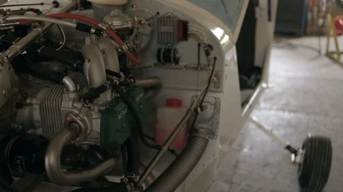 Jet engine inside of small airplane in repair hangar workshop, closeup view. Stockbeeldmateriaal 120806679