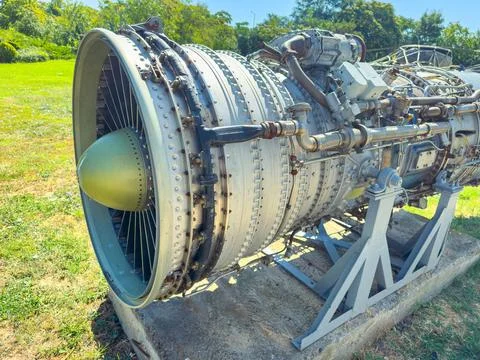 A jet engine stands on display in a grassy area within a park. The engine is  Foto stock