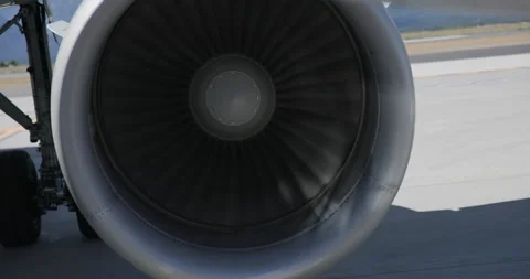 Jet Engine Turbine Blades Rotating While Aircraft Waits on Tarmac Stock Footage 329258764