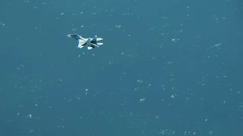 Jet fighter above the clouds and waves Video stock 123120526