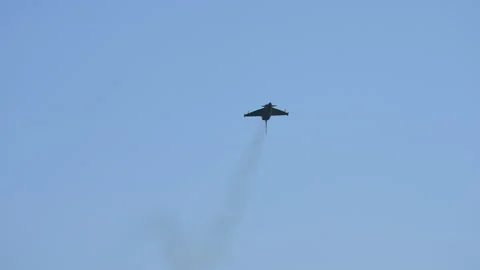 Jet fighter flying inverted toward camera in slow motion Stock Footage 319830669