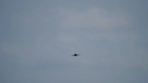 Jet fighter flying straight in clear sky Stock Footage 319835673