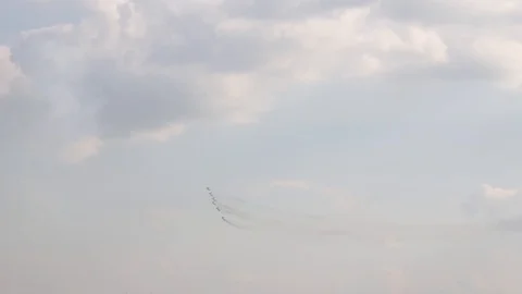 A jet fighter makes a figure "Barrel Snap Aileron Roll" at an air show. A group Stock Footage 125280487