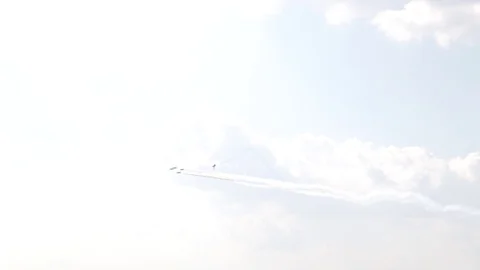 A jet fighter makes a figure "Barrel Snap Aileron Roll" at an air show. A group Stock Footage 125282948