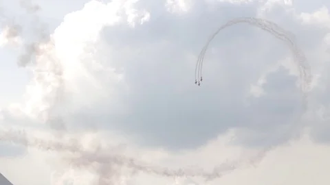 A jet fighter makes a figure "Barrel Snap Aileron Roll" at an air show. A group Stock Footage 125285189