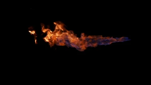 Jet of flame across frame against black Stock Footage 77134390