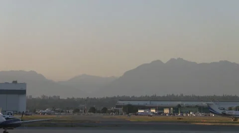 Jet Flys Thru Frame About to Land, Vancouver International Airport Video stock 991934