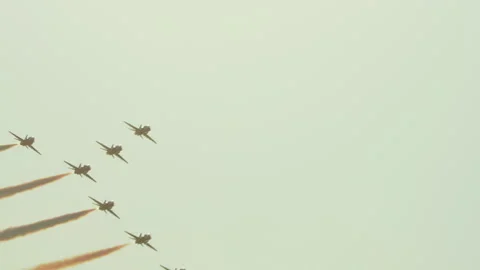 Jet formation flying at sunset with colored smoke trails 库存影片 334987885