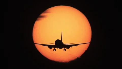Jet landing with sun behind it Stock Footage 89764017