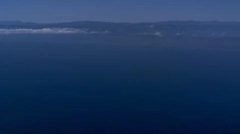Jet lying over ocean, air-to-air tail view Stock Footage 59475612