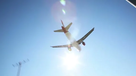 Jet plane approaching landing across blue sky. Stock Footage
