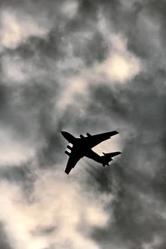 Jet plane on background of cloudy sky Stock Photos